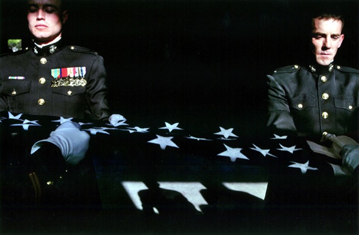 The day before the funeral of their friend, 2nd Lt. Jon Mueller, left and 1st Lt. Matthew Baumann practiced for hours folding a flag, making sure there would be no errors the next day. "That will be the last time his flag is folded, " Said Maj. Steve Beck, as he instructed them. "It has to be perfect."