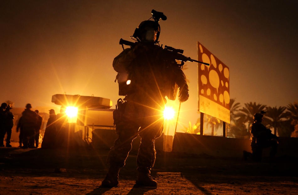 Fisher pulls security detail Dec. 10, 2008, for a meeting between intelligence troops and local residents near the site of a recent rocket attack in Diwaniyah, Iraq. He's excited to get selected for the task, and for the chance to finally wield his Squad Automatic Weapon in Iraq, three months into his deployment.  Trained for combat and primed to fight, Fisher arrived in Iraq in September 2008 along with about 3,800 troops of the 2nd Brigade Combat Team.  He had expectations for Iraq, and new ones for his l