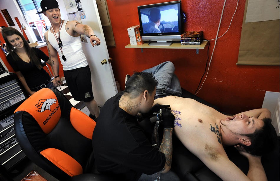 Ian and his new girlfriend, Devin Ervin, enjoy watching Nick 'Buddha' Nelson get a brass-knuckles tattoo March 14, 2009, in Lakewood, Colo. Ian got a matching one earlier that day. The design includes an 'N' and an 'F,' for their last names. "He's my best friend," Ian says. The tattoo "represents all the trouble we have gotten into together."  The trio were inseparable during Ian's leave from his tour in Iraq.  "We’re boyfriend and girlfriend," Devin said later.  "I don’t 
