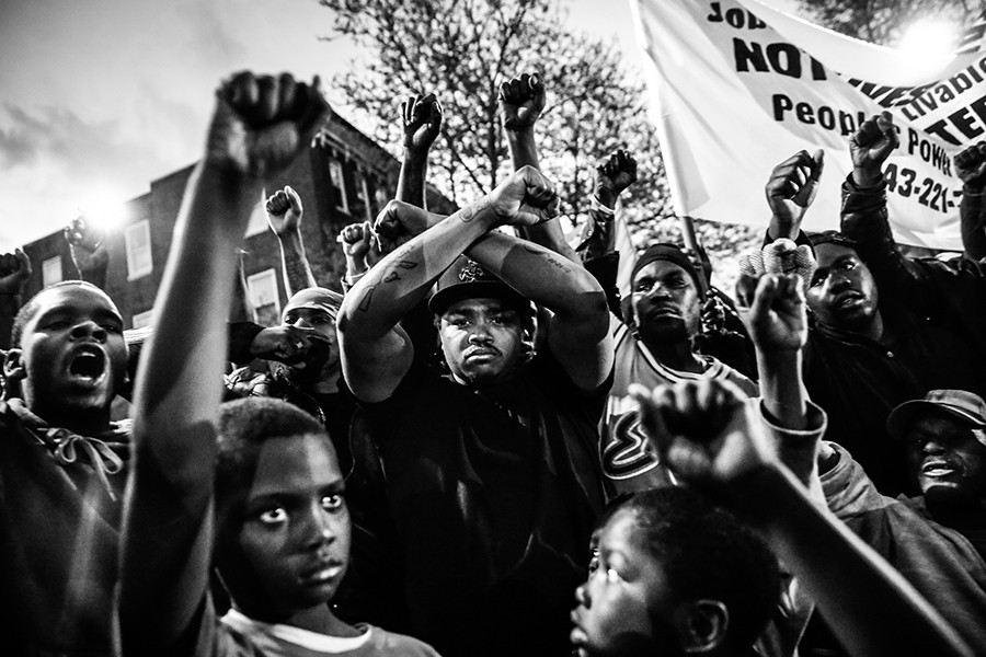 Protestors participate in a vigil for Freddie Gray down the street from the Baltimore Police Department's Western District police station in Baltimore, Maryland. Gray, 25, died from spinal injuries on April 19, one week after being taken into police custody (Drew Angerer, Getty Images – April 21, 2015).