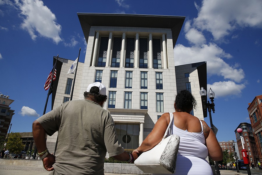 Raquel and her Uncle Bobby make their way towards the Suffolk County Juvenile Courthouse, to go before a judge and find out what will be necessary to get the girls back (Jessica Rinaldi, The Boston Globe).