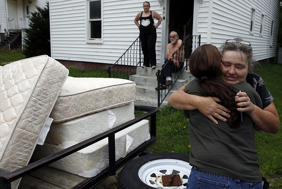 After months of searching for a new place to live, the Grants finally find a home they can afford on Craigslist in Lisbon, Maine. Anna Cunningham arrives to the family's new home with a donation of beds for the boys. Lanette grabs her and pulls her in for a grateful hug (Jessica Rinaldi, The Boston Globe).