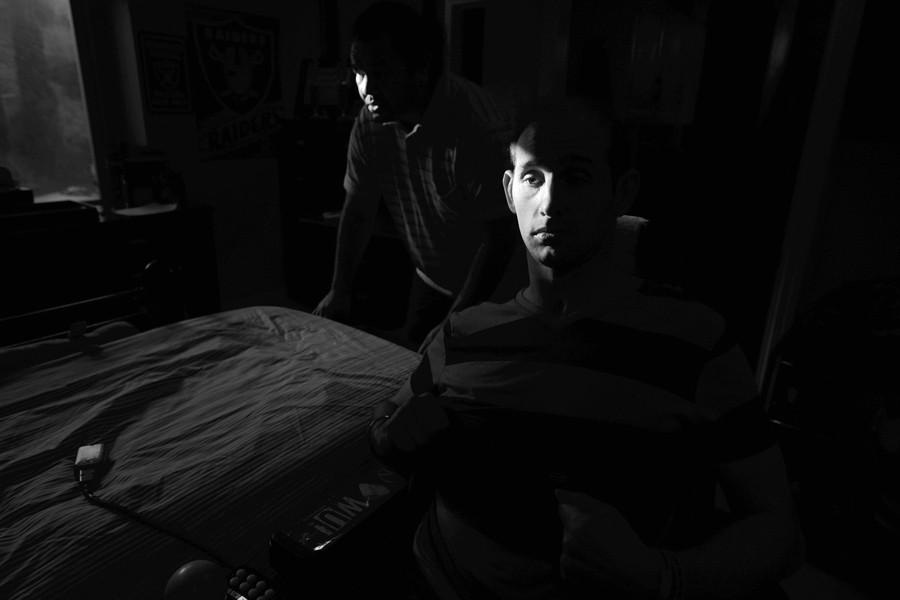 Aaron Rubin waits while a caregiver prepares his bed for an afternoon rest before dinner. (December 31, 2012)
