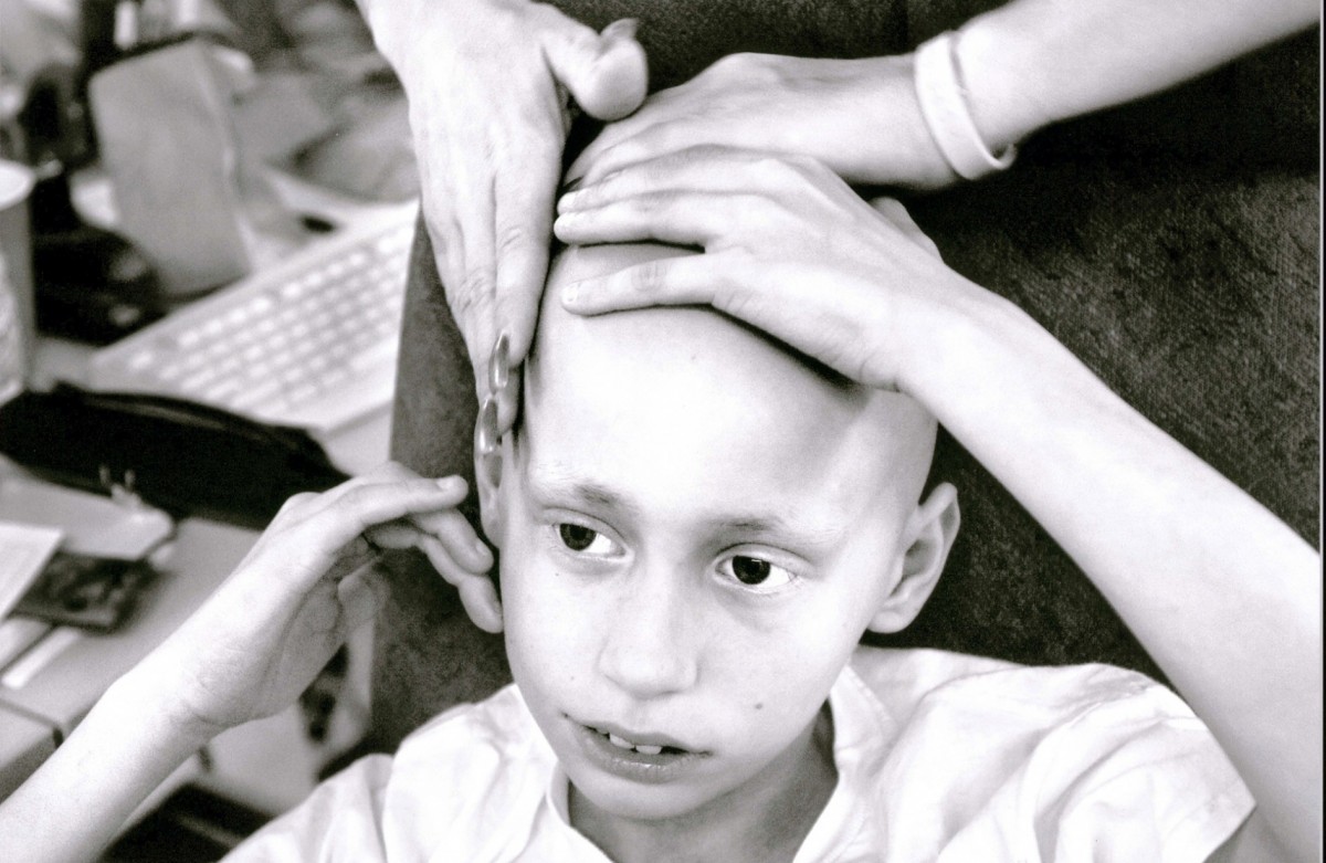 Derek Madsen, 10, gets a soothing massage from his mother, Cyndie French, at her Sacramento nail and tanning salon. "I'm going to do whatever it takes to make him happy, to see him smile." Cyndie says. A single mom of five, Cyndie had to give up her salon at a financial loss to care for her dying son. 