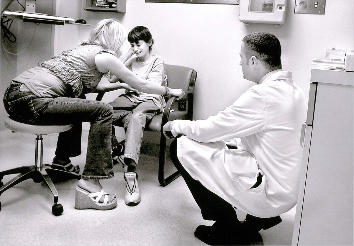 Derek is tearful as Cyndie tries to reason with him at the UC Davis Cancer Center on Feb. 14, 2006. She and Dr. William Hall argue that Derek should have a series of radiation treatments to shrink tumors spreading throughout his body and alleviate his pain. "Derek, you might not make it if you don't do this," Cyndie tells her son. Derek fires back: "I don't care! Take me home. I'm done, Mom. Are you listening to me? I'm done."