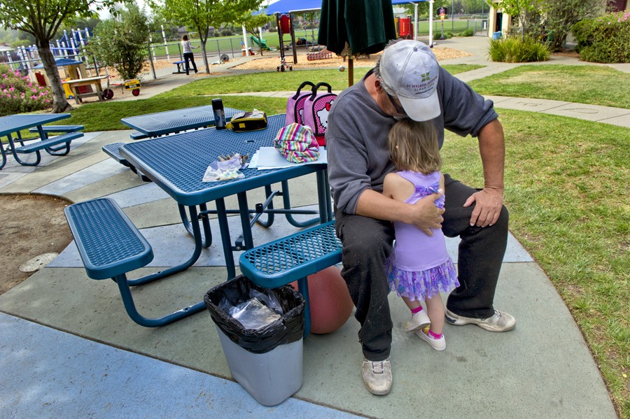 Ariel Winkler, 3, wakes up after her afternoon nap in the arms of her grandfather at St. John's Lutheran School where she and her sister are enrolled. (May 16, 2012)