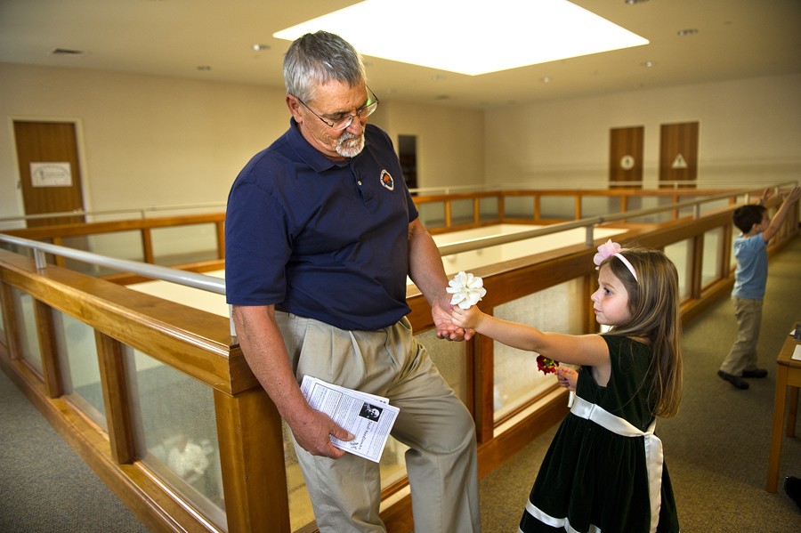 Eva Winkler, 5, gives her grandfather Don Hatfield, a flower on Mother's Day after she attended a children's ministry program at Grace Church in St. Helena. (May 16, 2012)