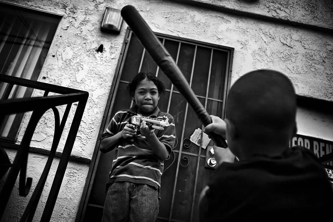 Edwin Cobbin’s younger brothers Albert, left, and Maddox play with toy weapons a few days after the slaying. Edwin Cobbin was lifting weights in the front yard of his house when a dark SUV pulled up. Two men got out, searched his pockets and asked him what gang he belonged to. Edwin told them he wasn’t in a gang, but the men shot him and drove away. (Barbara Davidson, Los Angeles Times - December 29, 2010)