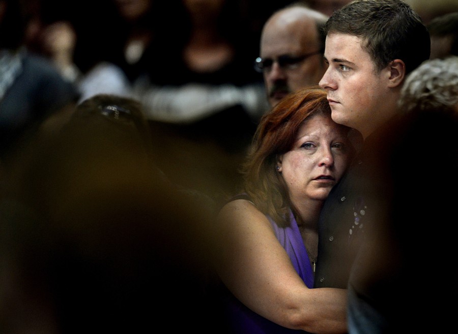 Theresa Hoover holds her son, Wil Boik, 22, during the funeral of her younger son, AJ Boik, 18, on Friday, July 27, 2012 at the Queen of Peace Catholic Church in Aurora. (Joe Amon - July 27, 2012)