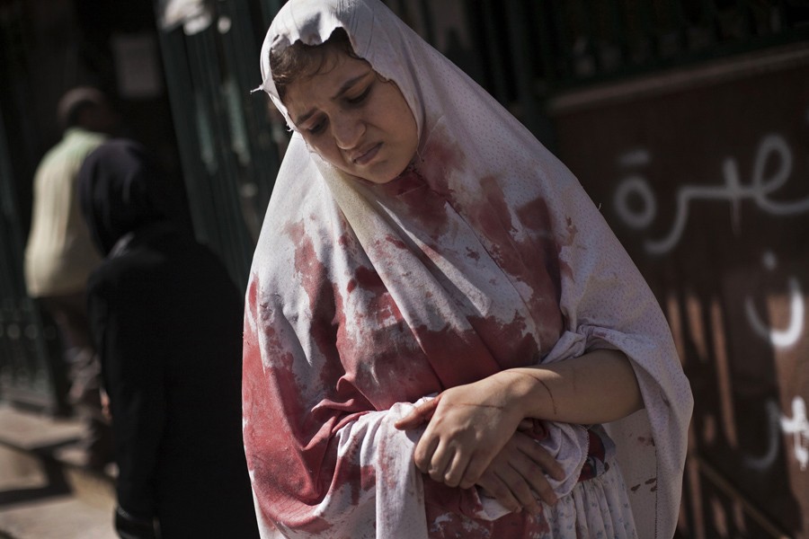 A wounded woman still in shock leaves Dar El Shifa hospital in Aleppo, Syria, Sept. 20, 2012. Dozens of Syrian civilians were killed, four children among them, in artillery shelling by Syrian government forces in the northern Syrian town. (Manu Brabo, Associated Press - September 20, 2012)