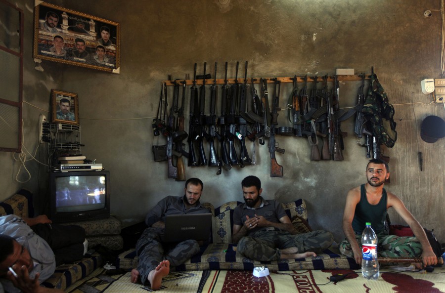 Free Syrian Army fighters sit in a house on the outskirts of Aleppo, Syria, June 12, 2012. (Khalil Hamra, Associated Press - June 12, 2012