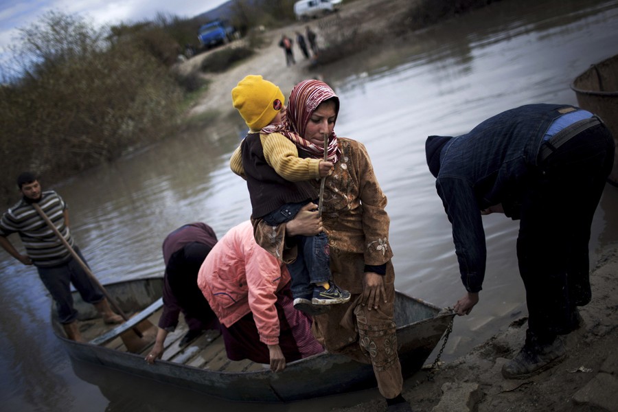Syrian refugees cross from Syria to Turkey via the Orontes River, near the village of Hacipasa, Turkey, Dec. 8, 2012. (Manu Brabo, Associated Press - December 8, 2012)