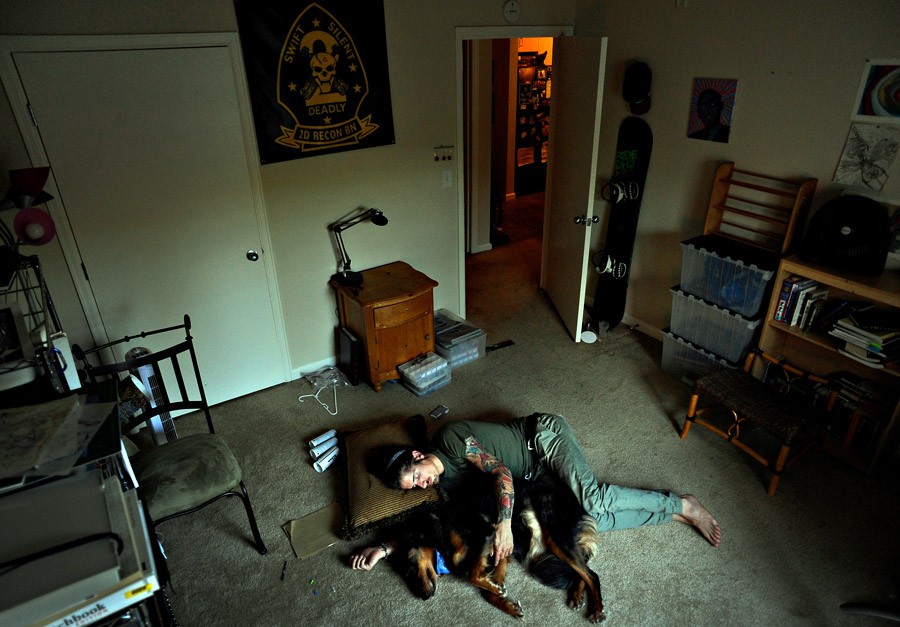 Scott lays on the floor with his dog, Jibby. He was exhausted and said, 'I'm tired of having bad f------ dreams. I can't take a nap because I'll feel worse. I fall asleep, but it doesn't make it better. Everybody says, 'With time, with time it will all go away.' So I'm waiting. He often credited his dog with saving his life. 'For me Jibby is very therapeutic. ... Sometimes I feel like a burden when I unload my emotions on friends, but Jibby's always there, regardless of what mood I'm in.' (Craig F. Walker, 