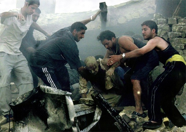 Baghdad - Iraqis rescue a man from the ruins of a building after a car bombing in central Baghdad. At least 10 people were killed, including three foreigners working to rebuild Iraqi power plants.