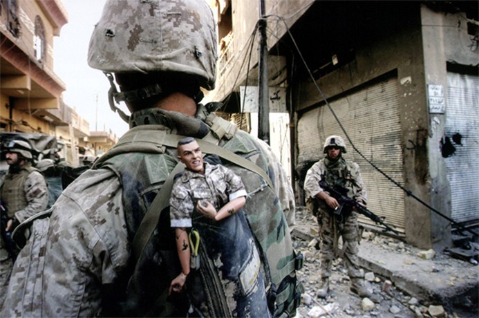 Fallujah - A 1st Division Marine carries a good luck mascot in his backpack as his unit pushed into western neighborhoods of Fallujah. Coalition forces launched a major November offensive for control of the city. 