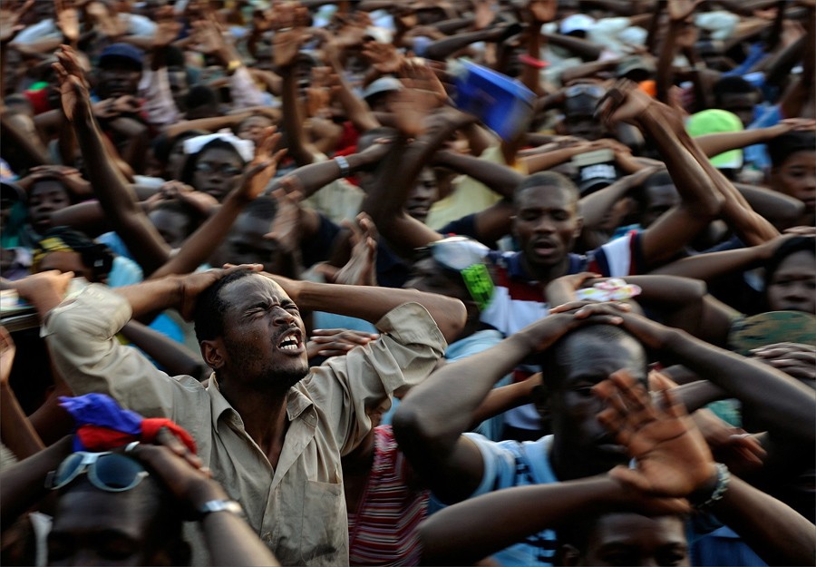 'Prayer' Survivors participate in a day of prayer at Champs du Mars in Port-au-Prince. Almost no one, it seemed, was spared tragedy. In a country whose government has all but collapsed, whose feeble economy has been crushed and whose people have been left destitute, the challenges were daunting. (Nikki Kahn, The Washington Post- January 23, 2010)